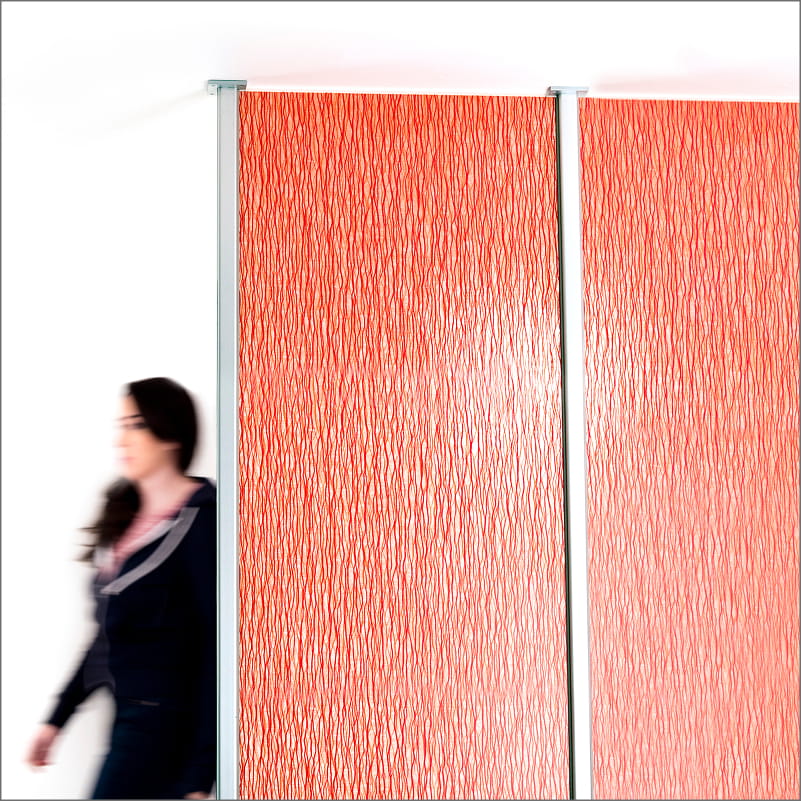 Floor-to-ceiling textured orange privacy panels secured by silver metal mounting tracks.