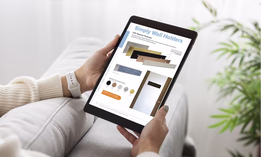 Hands holding a tablet displaying a digital product catalog