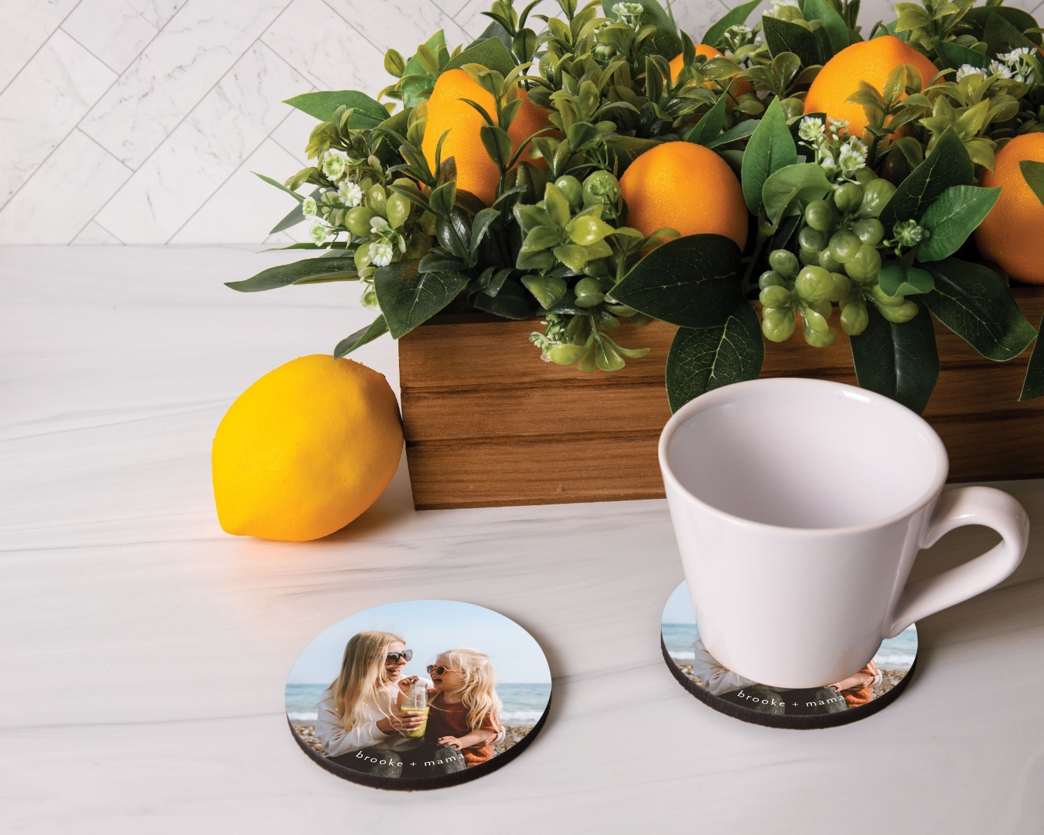 Two decorated round coasters with a mug and a plant
