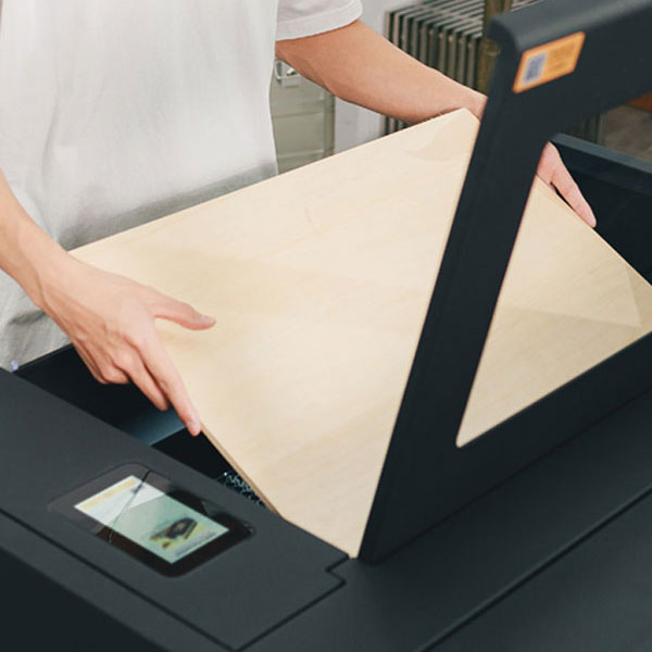 Placing wood sheet into Beambox II laser engraver