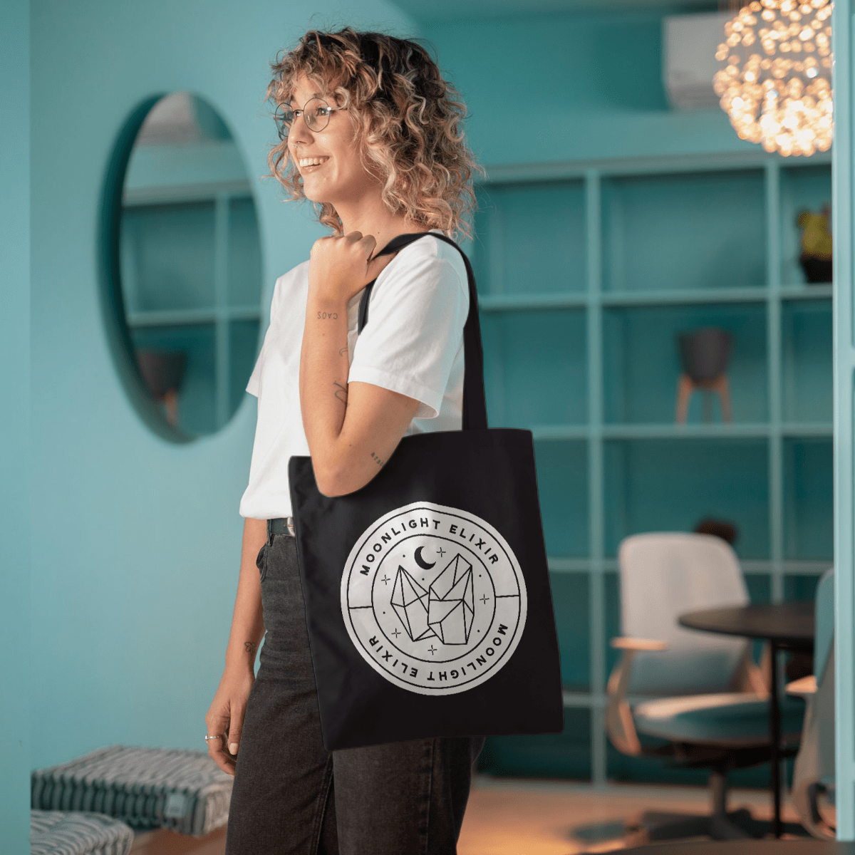 girl holding black bag with white design on the front
