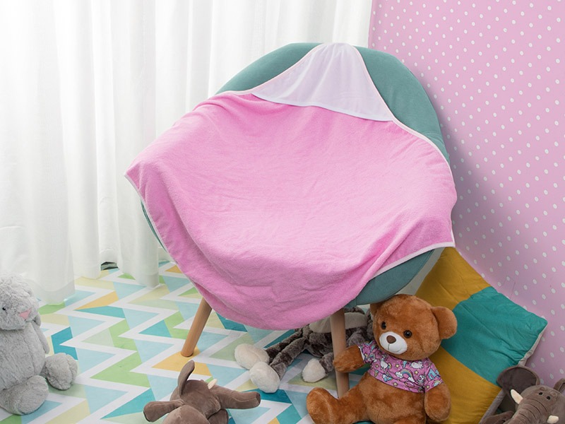 Pink Hooded Baby Towel laid across a chair in nursery