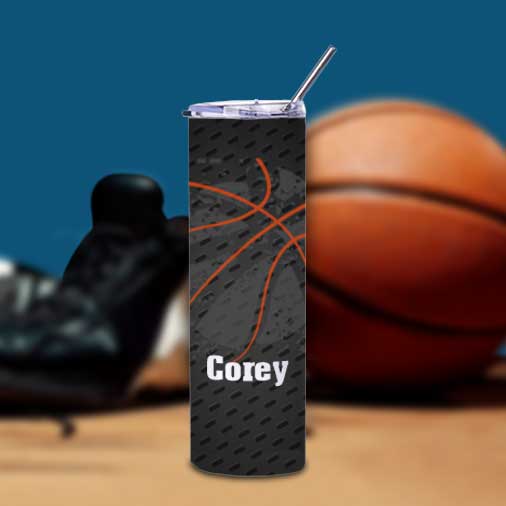 30oz straight stainless steel tumbler with straw and lid customized with Corey, an image of a basketball, with basketball and shoes in the background