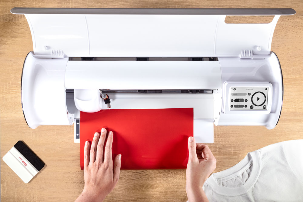 Siser Juliet vinyl cutter hands loading red vinyl