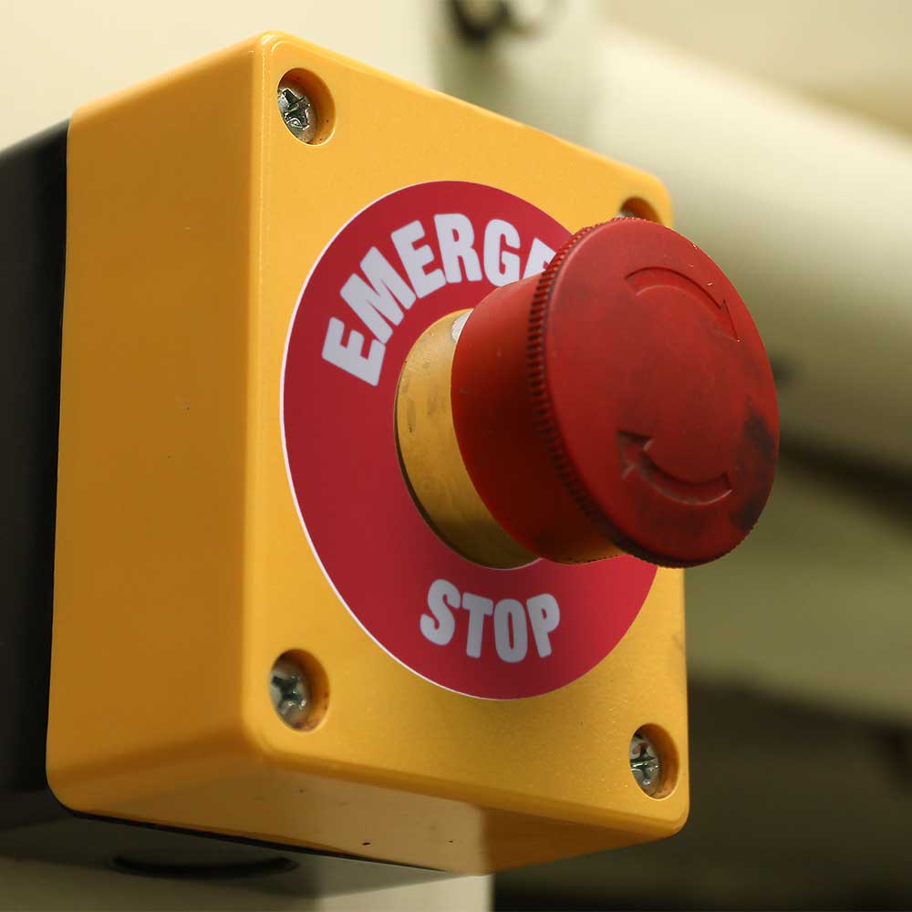 Button with emergency stop sign around it