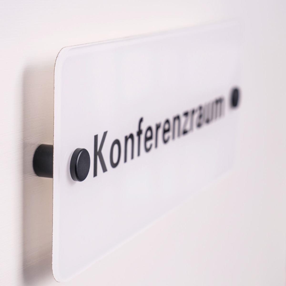 Sign being held up with black standoffs