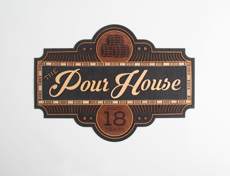 The Pour House sign made of inlaid wood