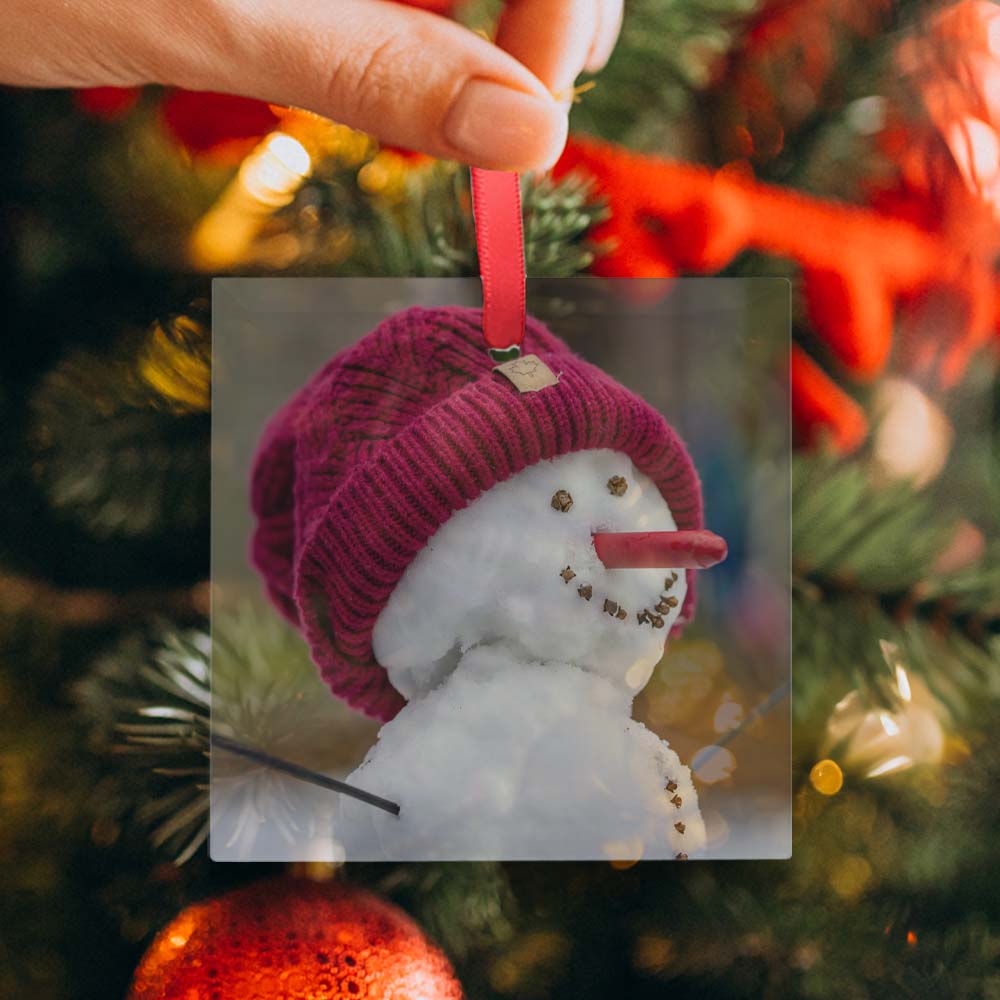 Glass ornament being hung on a tree