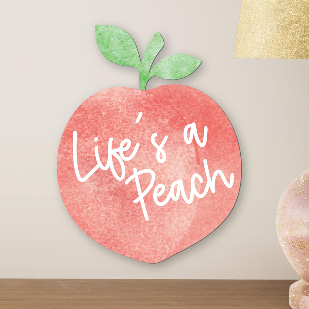 Life's a peach sign hanging on wall