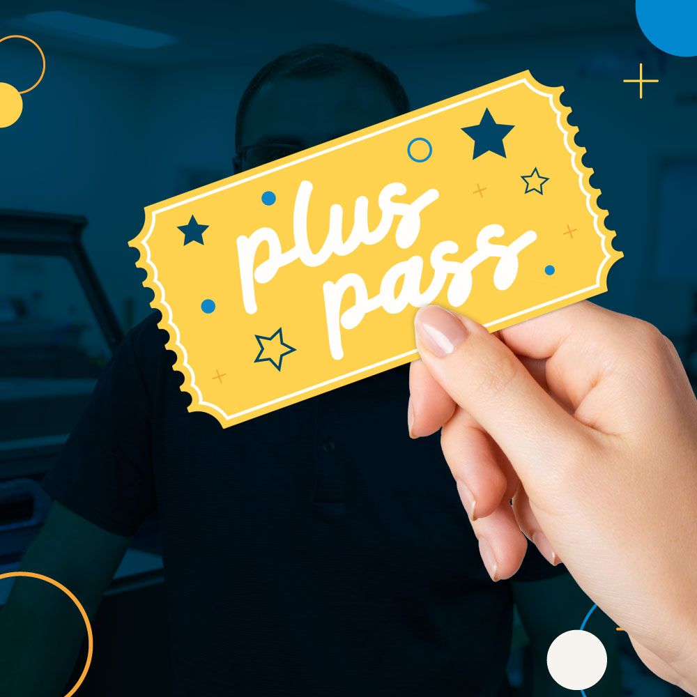 dark blue background image with JPPlus employee and a hand holding a plus pass ticket